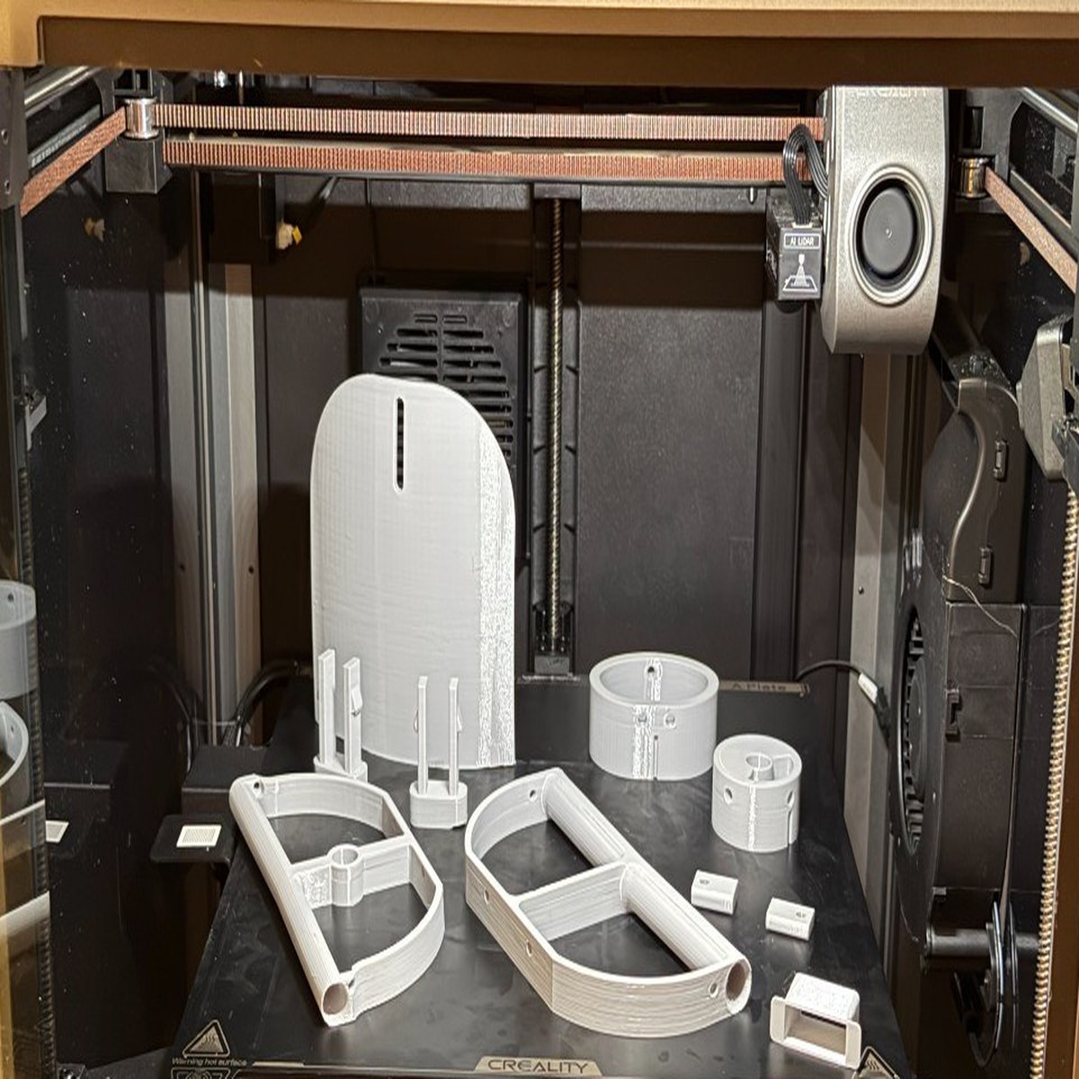 K1 Max — batch of structural airframe parts on build plate after print